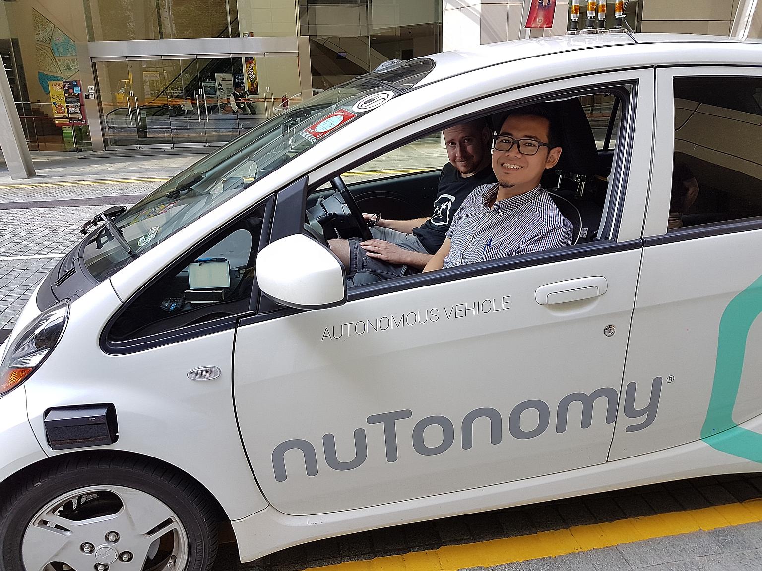 The reporter with nuTonomy safety engineer Greg Butron in the start-up's self-driving Mitsubishi i-MiEV.