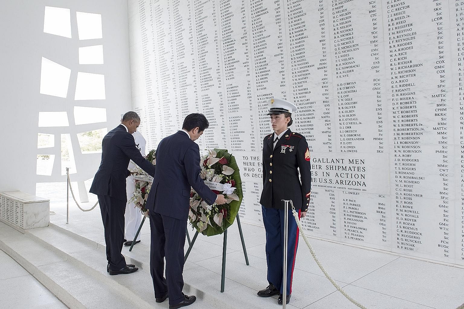 Mr Obama and Mr Abe placing wreaths at the USS Arizona Memorial in Hawaii on Tuesday to honour those killed in the 1941 Pearl Harbour attack. Mr Abe and Mr Obama at a joint press conference in Hawaii on Tuesday, held after both leaders visited Pearl 