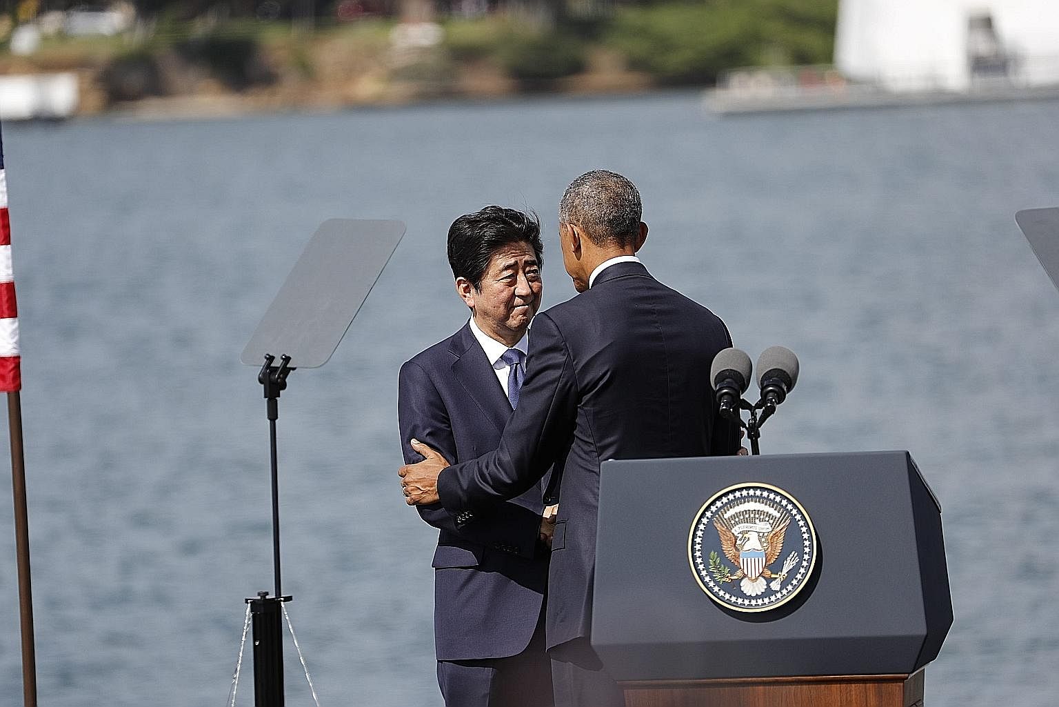 Mr Obama and Mr Abe placing wreaths at the USS Arizona Memorial in Hawaii on Tuesday to honour those killed in the 1941 Pearl Harbour attack. Mr Abe and Mr Obama at a joint press conference in Hawaii on Tuesday, held after both leaders visited Pearl 