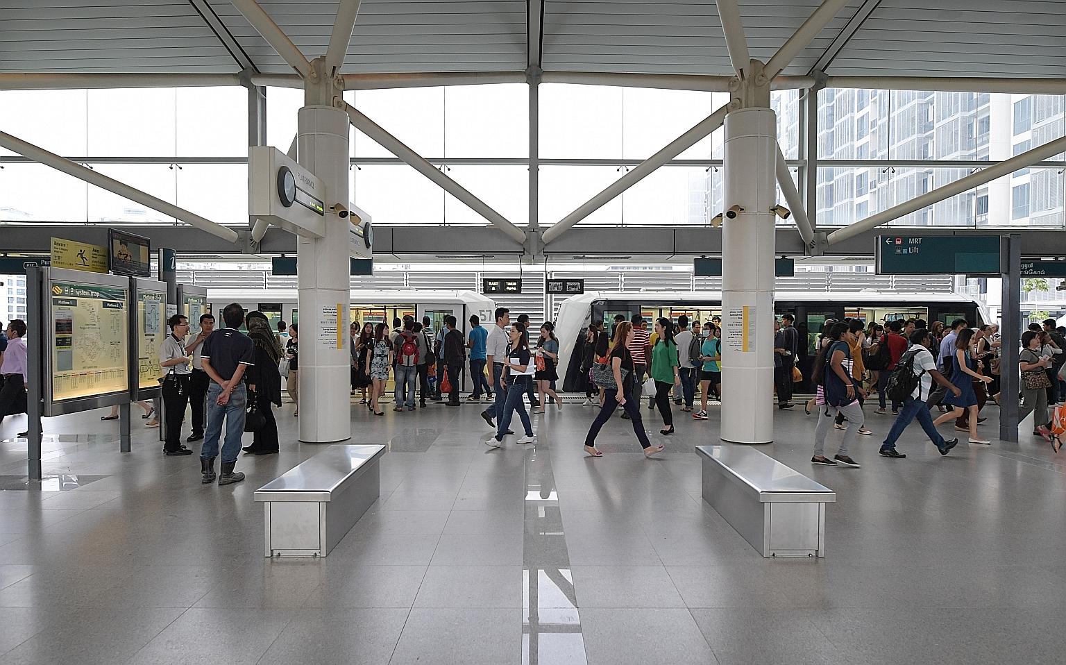 Commuters at the Punggol LRT station during the morning rush hour yesterday. The two-car trains introduced on the east loop of the LRT line yesterday will operate during the morning and evening peak periods.