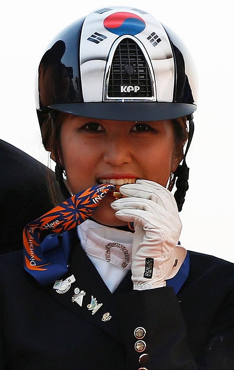 Ms Chung in a 2014 photo after winning an Asian Games gold medal in an equestrian event. Samsung Electronics' sponsorship of her riding career is an element of the investigation into her mother Choi Soon Sil's involvement in an influence- peddling sc