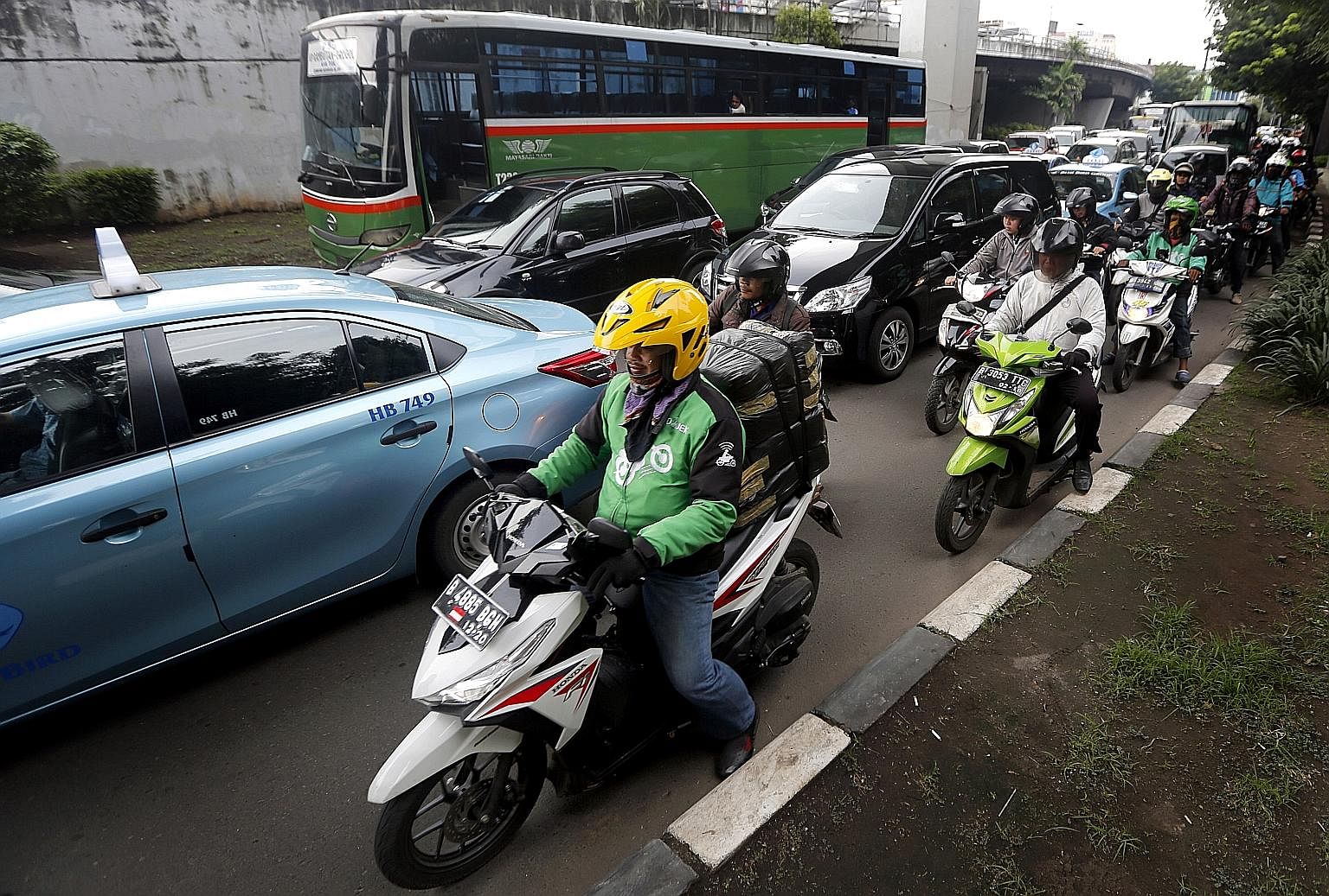 A Go-Jek delivery rider in Jakarta. The firm launched Go-Pay to bridge the gap between consumers who pay with cash and its mobile app, which accepts digital payments.