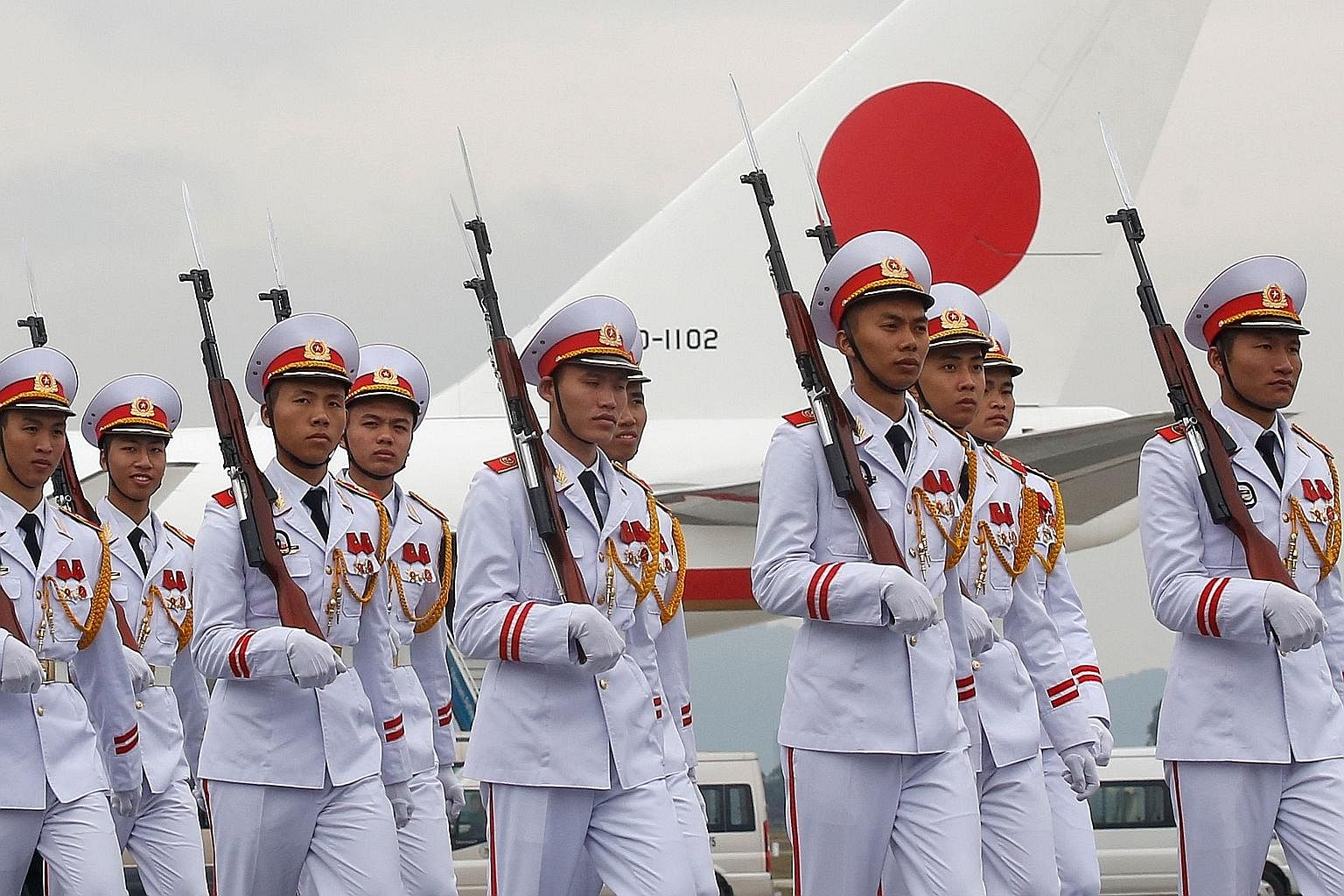 A Vietnamese honour guard in front of the plane transporting Mr Abe from Hanoi back to Tokyo yesterday. The Japanese leader's six-day regional tour also included the Philippines, Australia and Indonesia.
