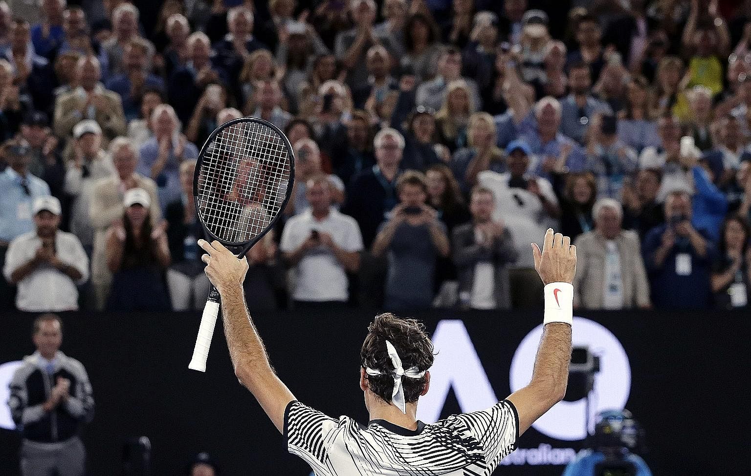 Roger Federer, taking in the Melbourne crowd's adulation after his semi-final win, has reached his 28th Grand Slam final, 14 years after his first one, with his five-set victory over fellow Swiss Stan Wawrinka.