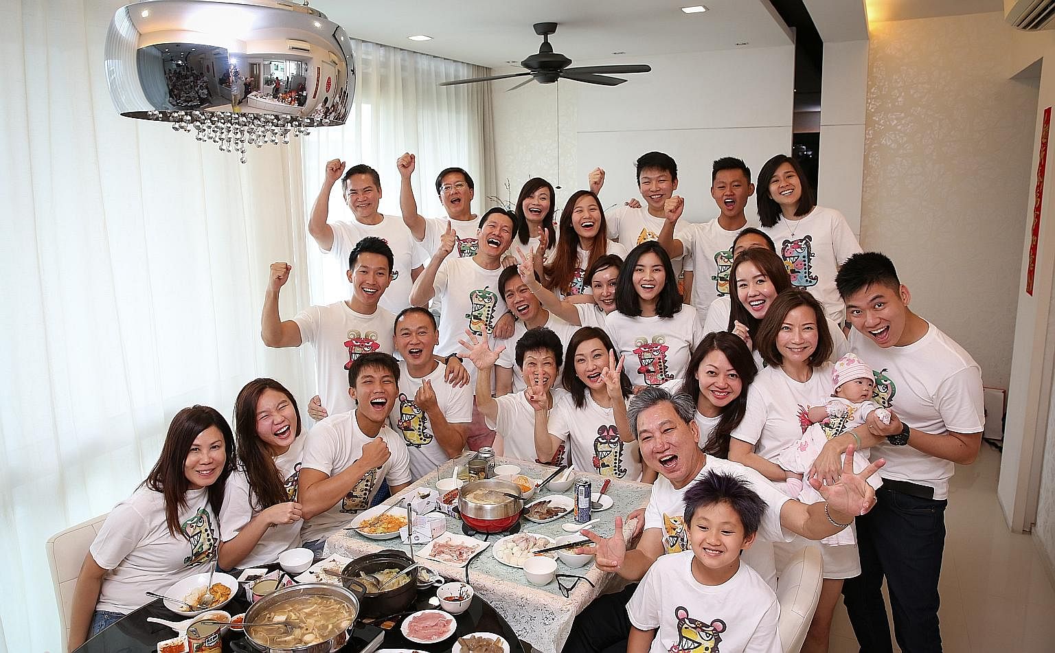 The Yeo family dressed in matching T-shirts bearing their respective zodiac signs at their reunion lunch yesterday. Twenty-six members of the family spanning four generations were present; two could not make it.