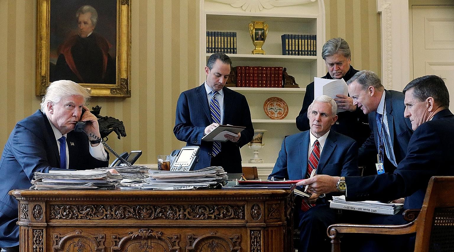 President Trump, with (from left) Chief of Staff Reince Priebus, Vice-President Mike Pence, Mr Bannon, Communications Director Sean Spicer and National Security Adviser Michael Flynn, speaking on the phone with Russian President Vladimir Putin, at th