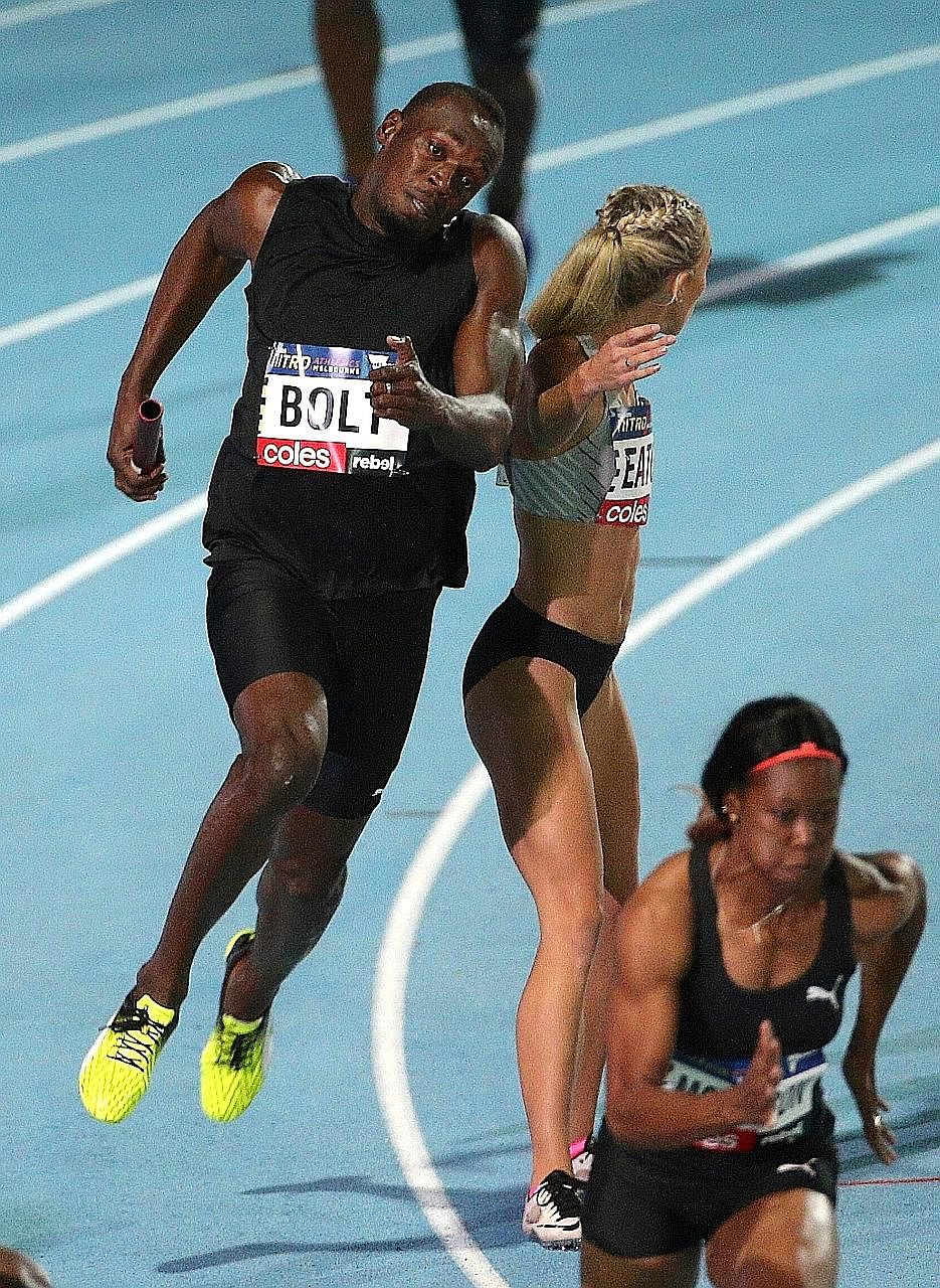 Olympic champion Usain Bolt collides with Team New Zealand's Olivia Eaton during the mixed 4x100m on the second night of the Nitro Athletics series, which saw six teams of 12 male and 12 female athletes compete in a mixture of old and new events. The
