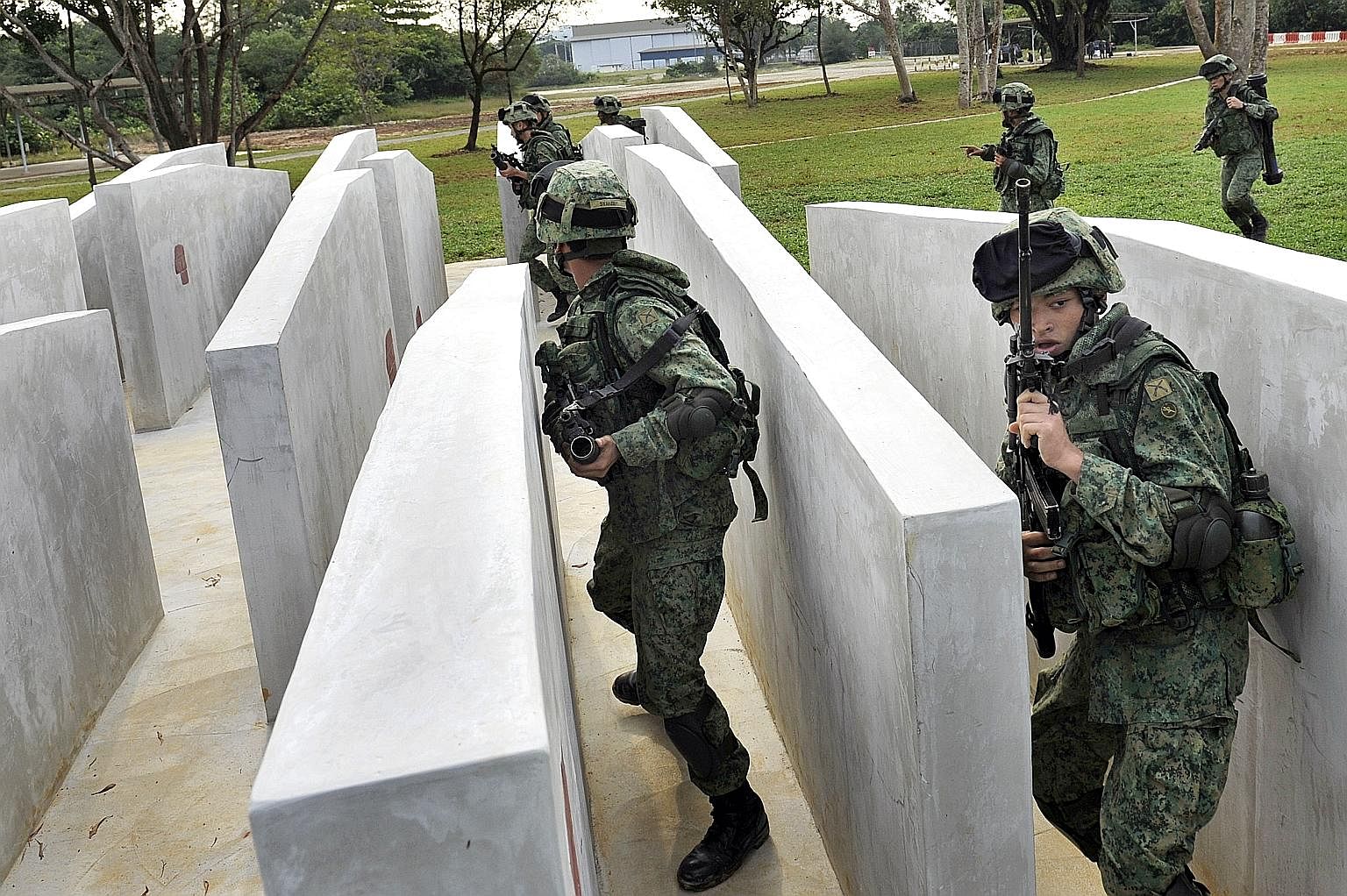 National servicemen during an obstacle-course training session. They will soon be trained in cyber-security tactics as well.