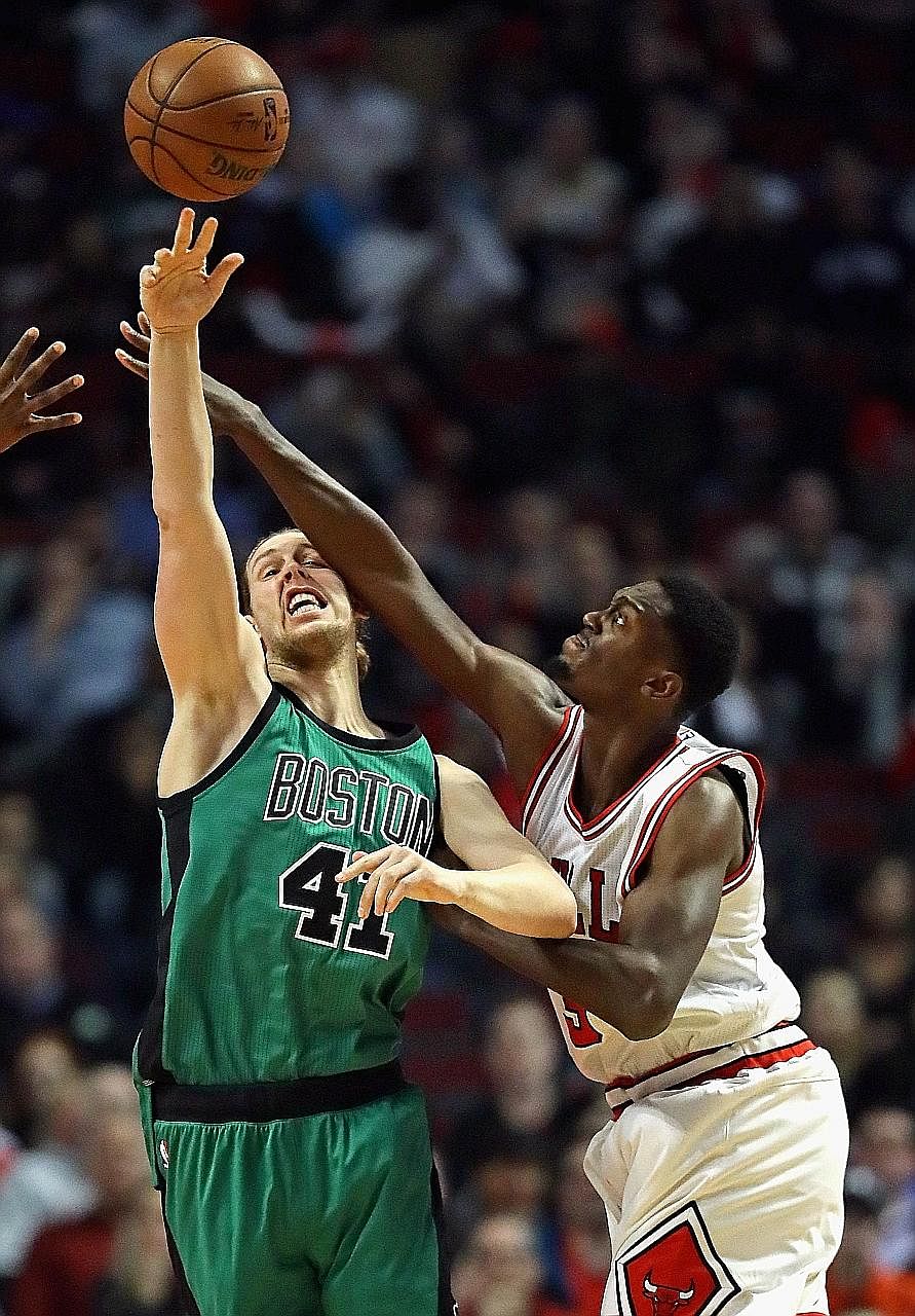 Celtics centre Kelly Olynyk makes a pass under pressure from Bulls forward Bobby Portis at the United Centre. Olynyk had 17 points off the bench while Portis scored 19 of the 34 points contributed by the Bulls' reserves.