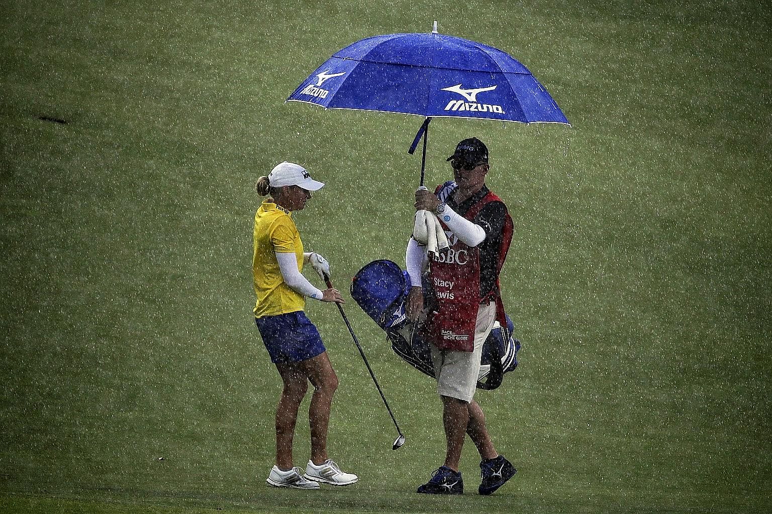 American Stacy Lewis battling the elements during the second round of the HSBC Women's Champions. The 2013 champion carded a one-over 73 yesterday, after a 68 on Thursday.
