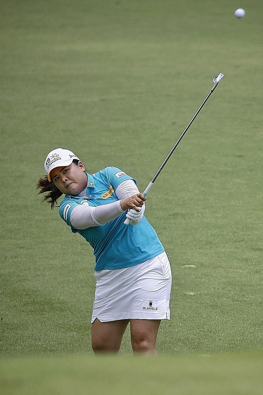 South Korean Park In Bee hitting a shot at the New Tanjong course's 11th hole yesterday. She went on to make one of nine birdies in her final round at the par-four hole and lift the HSBC Women's Champions trophy.