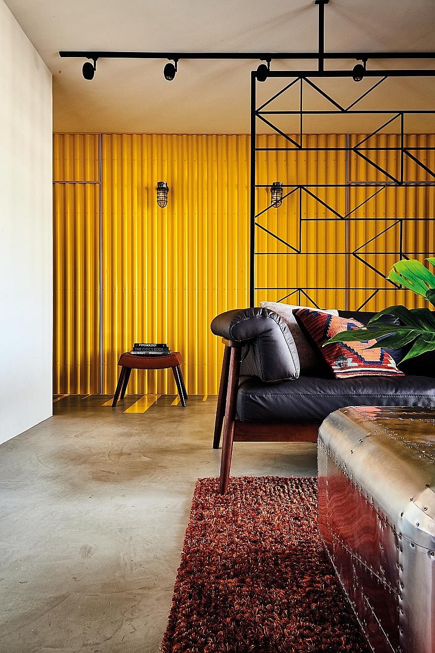 A bright yellow 'cargo container' forms the backdrop to the living room.