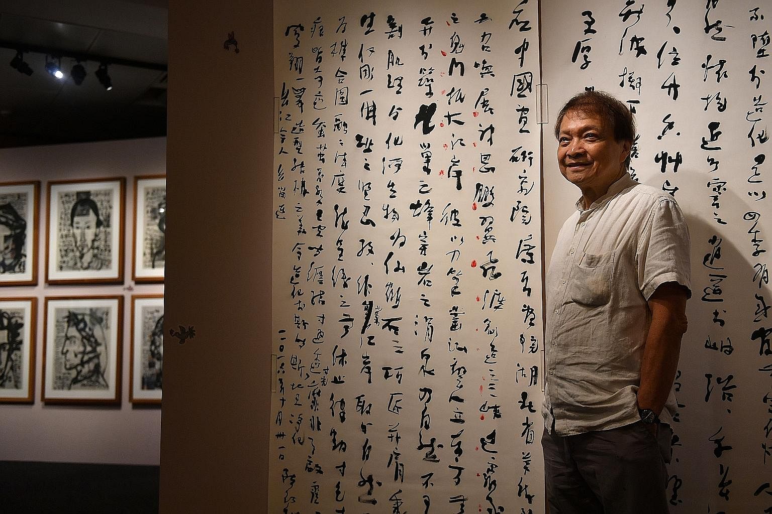Artist Tan Swie Hian at the National Library’s exhibition of his artworks, Anatomy Of A Free Mind – his biggest show to date. More than 100 of his works will be on display until April 24. Behind him is The Preface To Tour Of Three Gorges Stone Engravings 