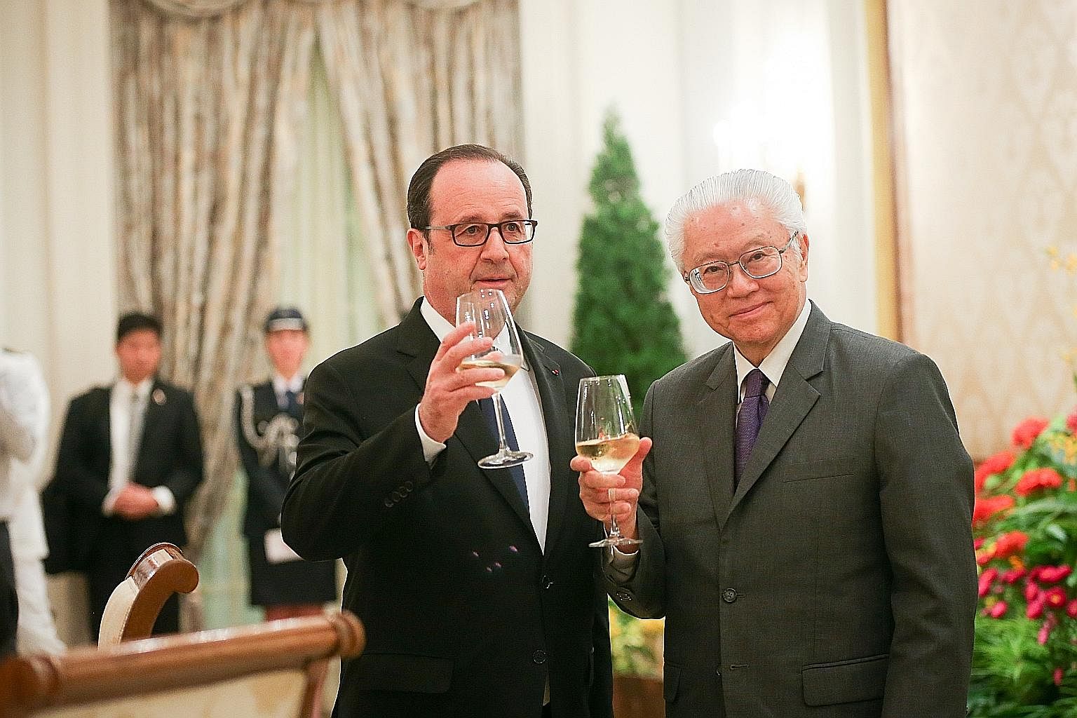 French President Francois Hollande inspecting the guard of honour with President Tony Tan Keng Yam at a welcome ceremony at the Istana yesterday. Mr Hollande is the first sitting French president to visit Singapore. Dr Tan and Mr Hollande at a state 