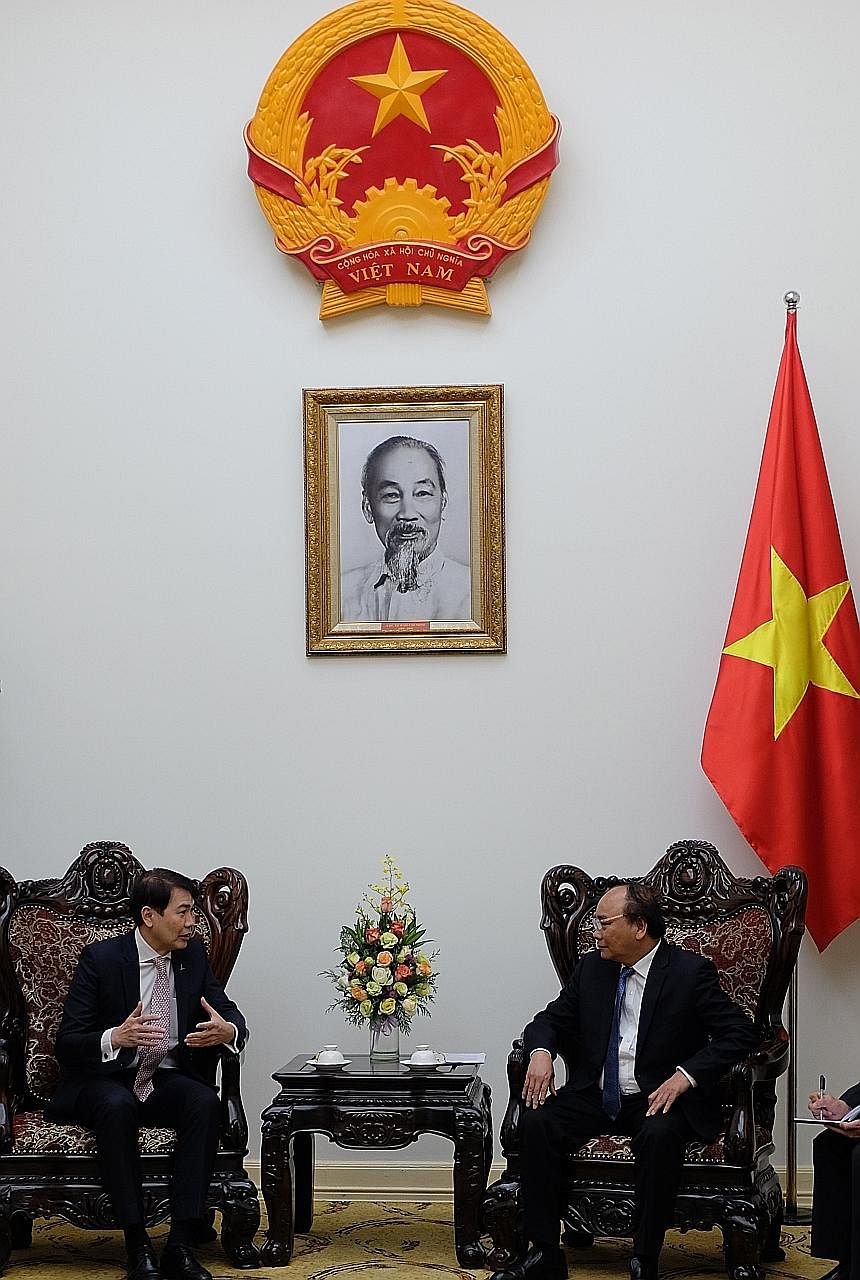 CapitaLand's Mr Lim (left) with Mr Phuc, Vietnam's Prime Minister, yesterday. The developer sees great potential in the country.