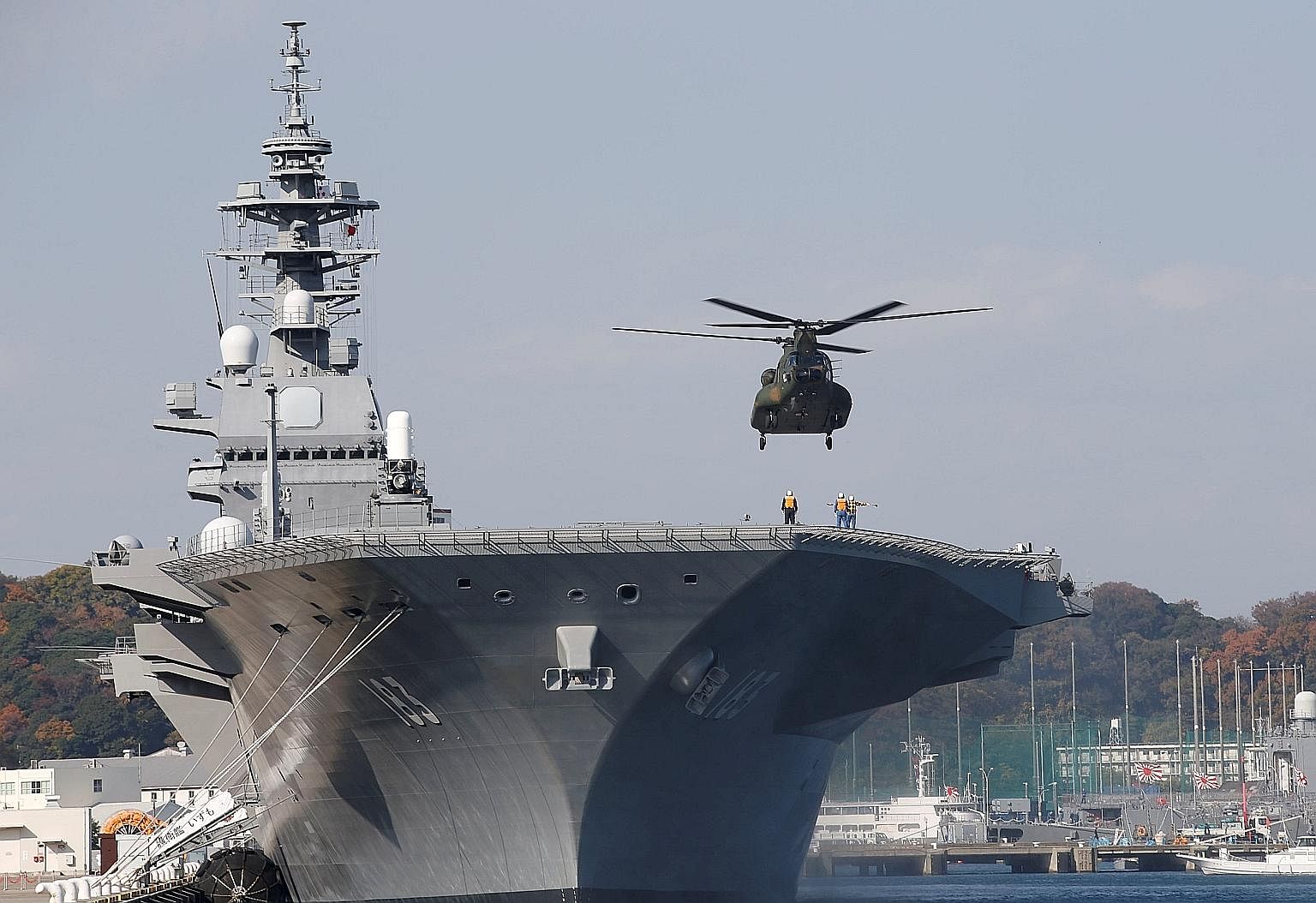 A helicopter landing on the Izumo at the Japan Maritime Self Defence Force's Yokosuka base south of Tokyo.
