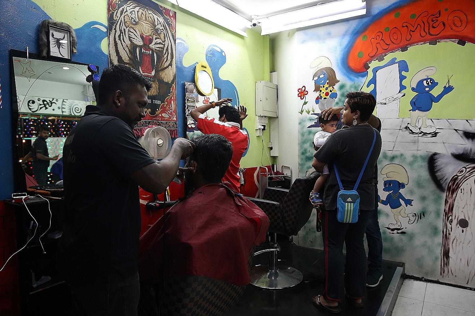Business is slow during the day at Romeo Hair Studio at Block 1A, with most Malaysians heading straight back to Johor after work, and residents in this and neighbouring blocks having moved out under Sers. But things brighten up somewhat in the evenin