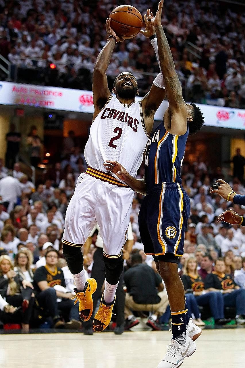Kyrie Irving getting a shot over the Pacers' Jeff Teague. The Cavaliers point guard led all scorers with 37 points to help hosts Cleveland to a 117-111 win in their Eastern Conference first-round tie.