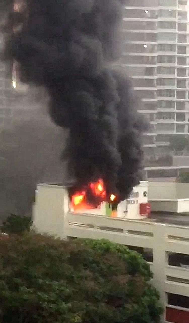The fire at Block 282, Bishan Street 22 yesterday, as seen from housewife Asther Tung's home in Block 232.