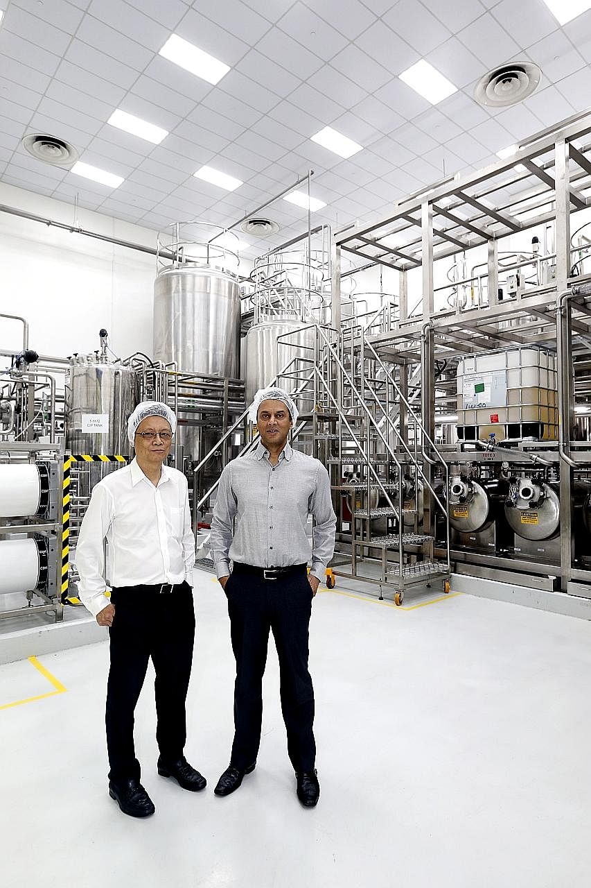 EEC managing director Lee Kwok Kuen and Kimberly-Clark's Asia-Pacific vice-president of product supply Peter D'Silva in front of the water purification system that EEC developed for Kimberly-Clark's new baby wipes production line.