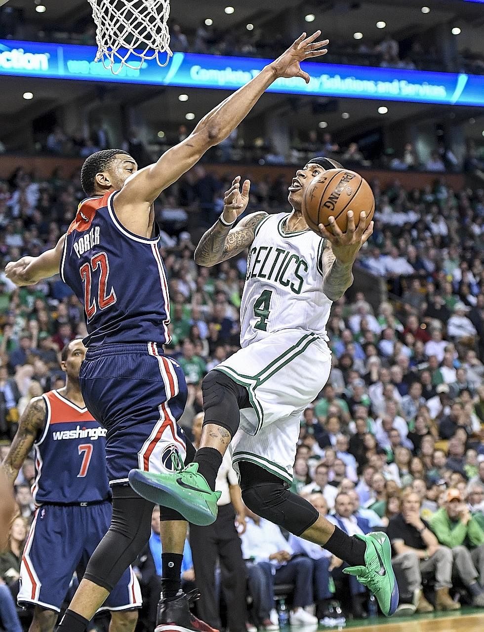 Celtics star Isaiah Thomas driving to the hoop against Wizards forward Otto Porter Jr during Game Two in Boston. Despite going through a six-hour dental procedure the day before, Thomas connected on 18 of 33 shots.