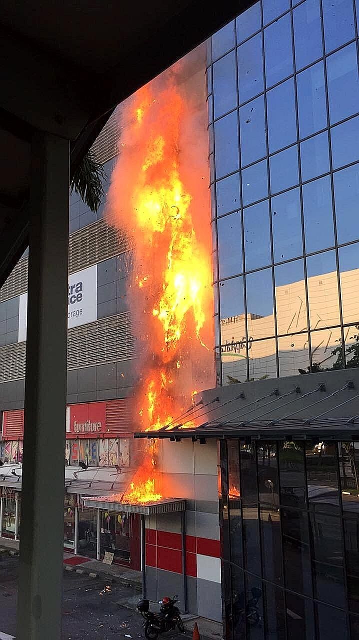 About 50 people were evacuated from the burning building at 30 Toh Guan Road in Jurong yesterday. A 54-year-old woman died after suffering burn injuries.