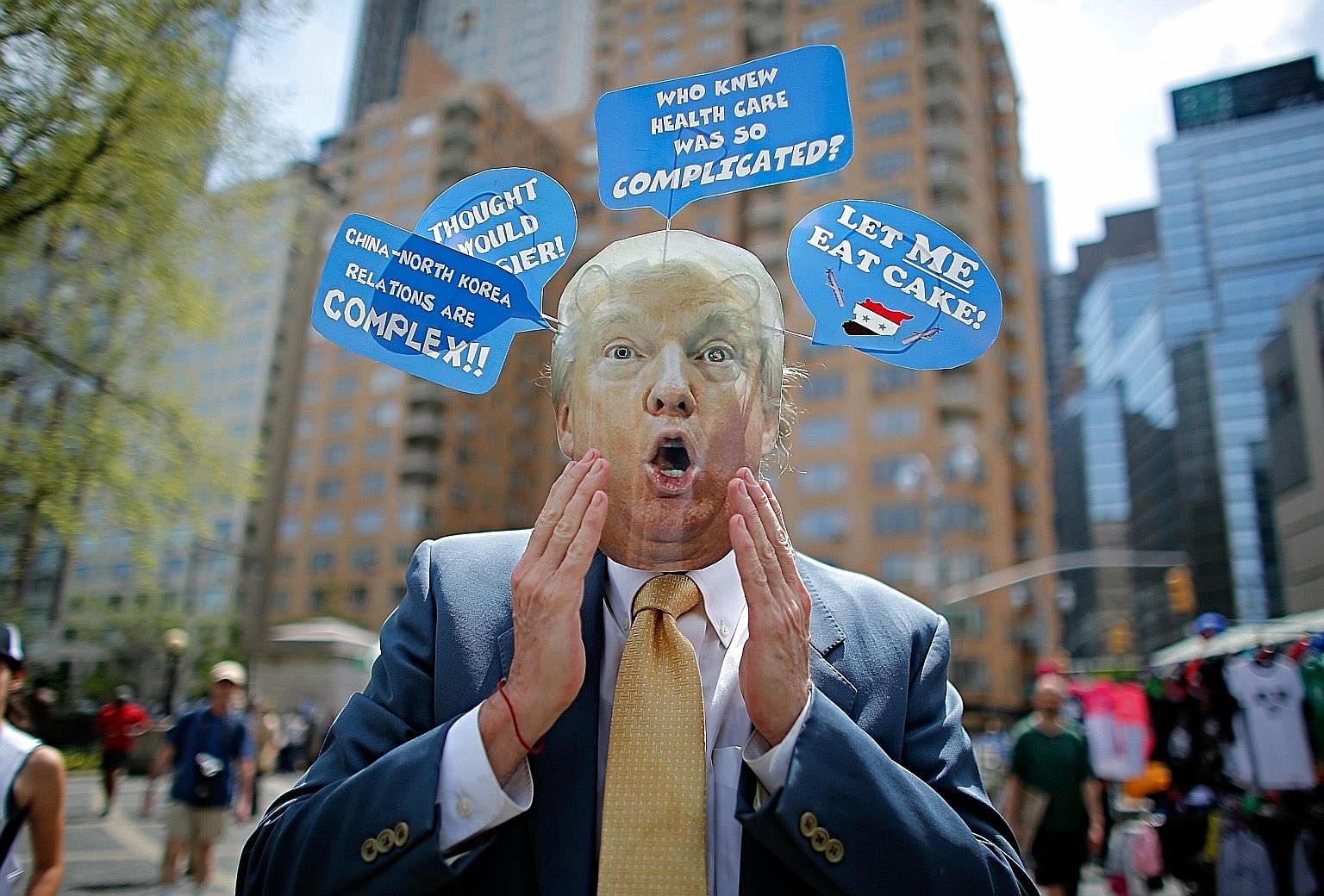 A man in New York wearing a Donald Trump mask taking part in the "100 Days of Failure" protest on April 29. The surprises from the Trump administration's first 100 days have been both positive and negative.