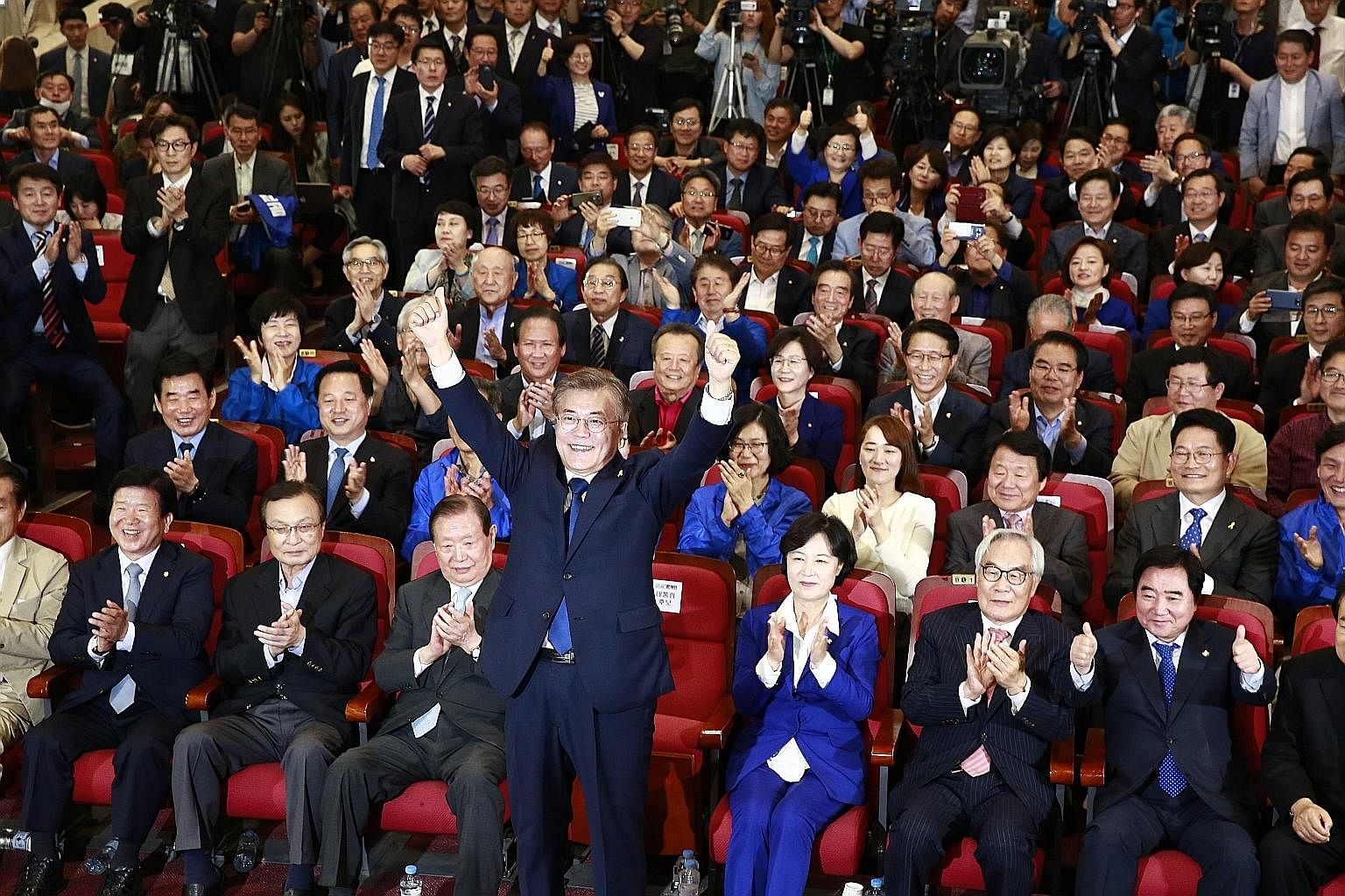 Mr Moon Jae In of the Democratic Party celebrating with supporters at the National Assembly in Seoul, after exit polls showed he would be South Korea's new president. People watching a live broadcast of election coverage in Seoul's Gwanghwamun Square