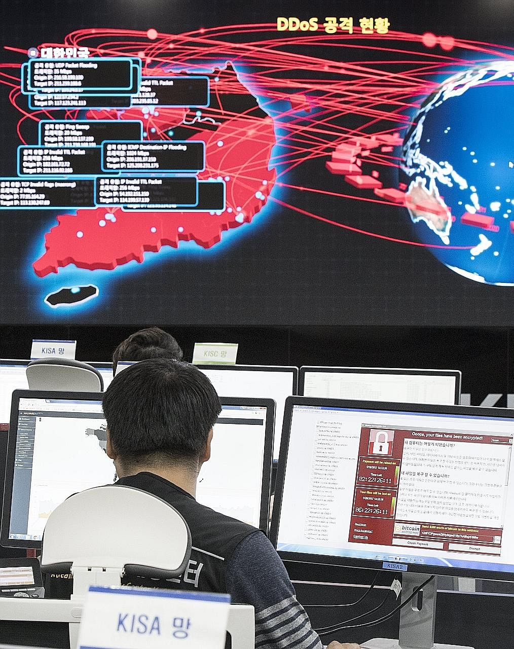 Employees watching an electronic board to monitor possible cyber attacks at the Korea Internet and Security Agency in Seoul yesterday.