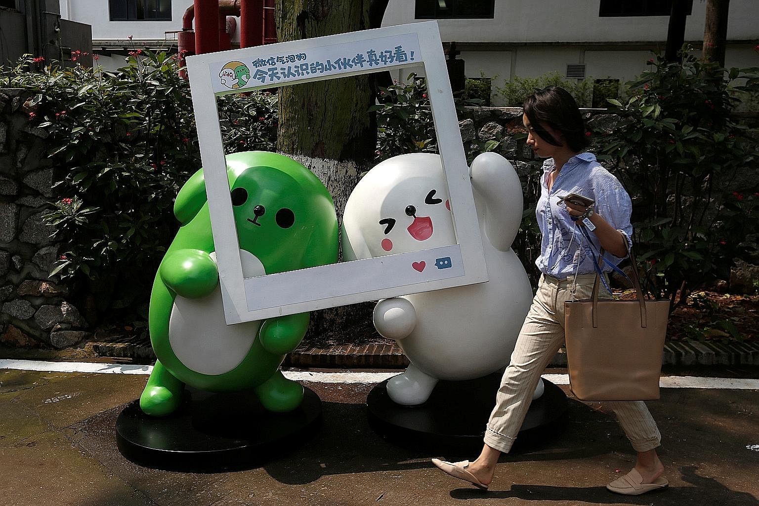 Mascots of Tencent's mobile chat service WeChat inside Guangzhou's TIT Creativity Industry Zone. With a market value of over $460 billion, Tencent is now worth almost half as much as all the companies listed on the Singapore Exchange, even though it 