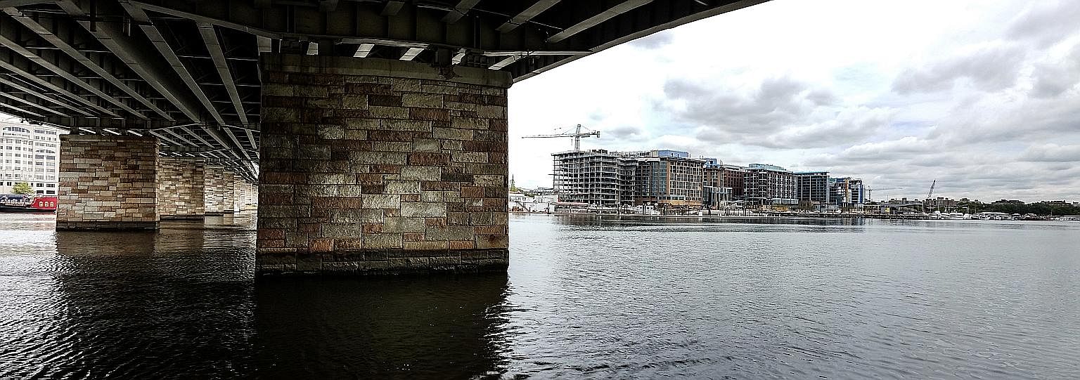 Seen from under Francis Case Memorial Bridge, The Wharf project (to the right) will help transform the waterfront - part of a wave of urban renewal in Washington DC. Above: "Empty nester" Terry Mattingly and her husband moved to Washington DC from a 