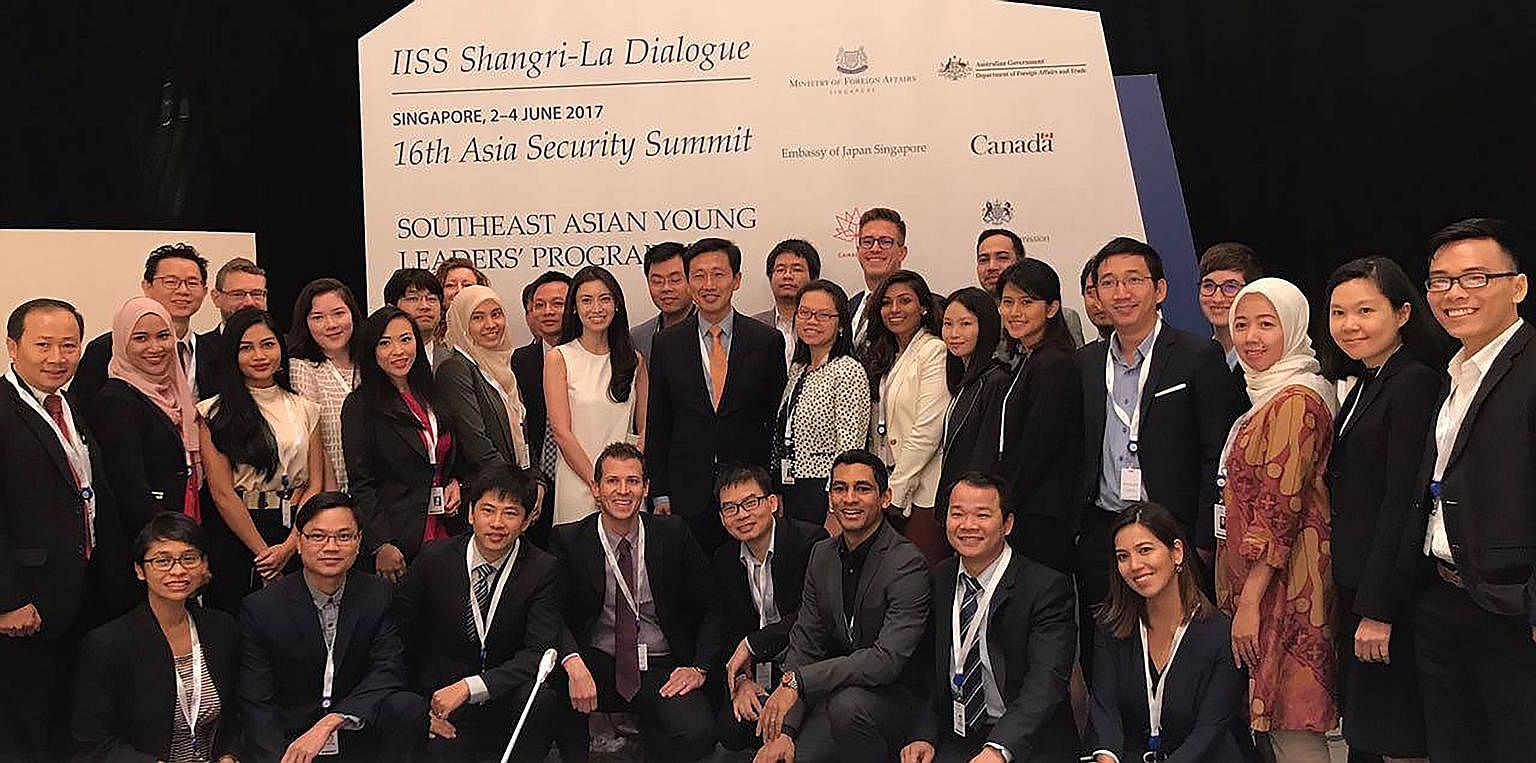 Mr Ong Ye Kung (at centre) with participants of the Southeast Asian Young Leaders' Programme at the IISS Shangri-La Dialogue yesterday. He hopes Asean states can work together to prepare the next generation for the future and exchange ideas on how to