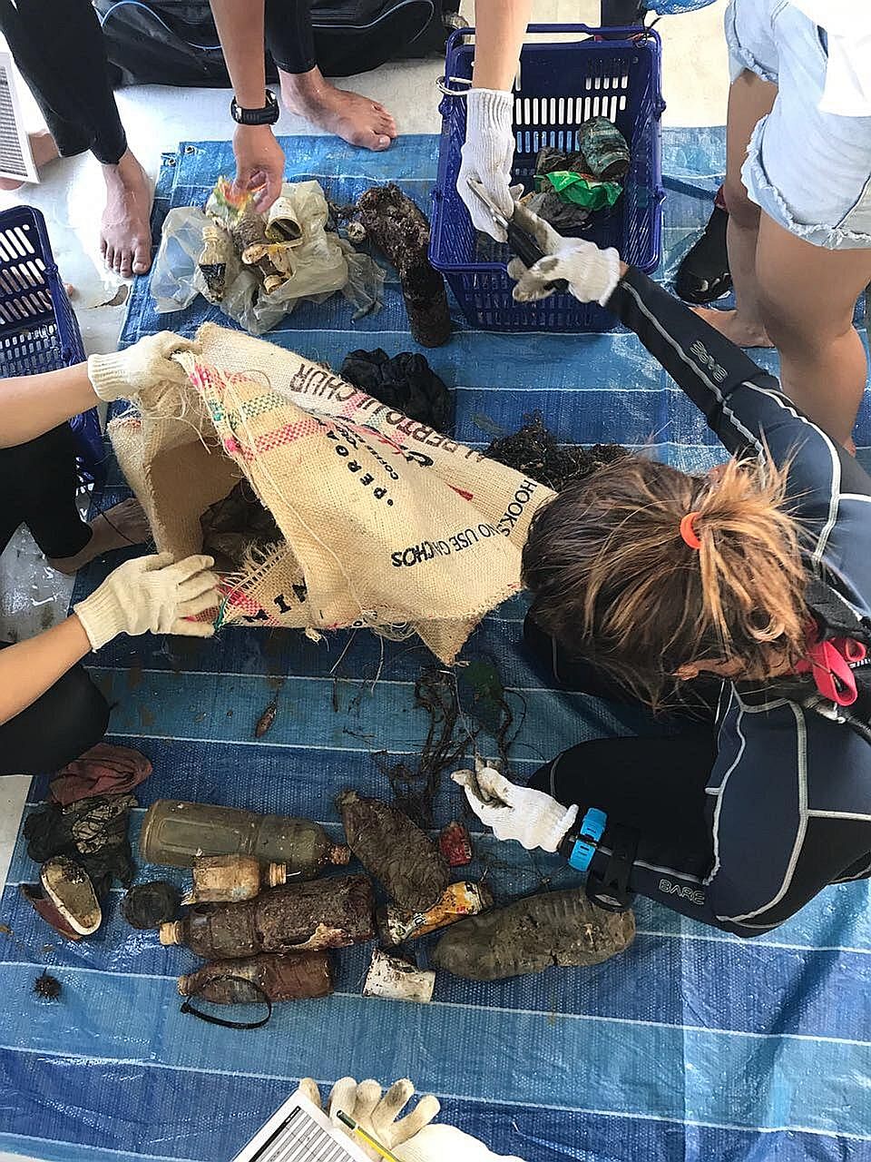 Volunteers sorting out marine trash at the Sunday event to mark World Oceans Day today. It was the first community-led underwater clean-up effort here involving multiple partners.