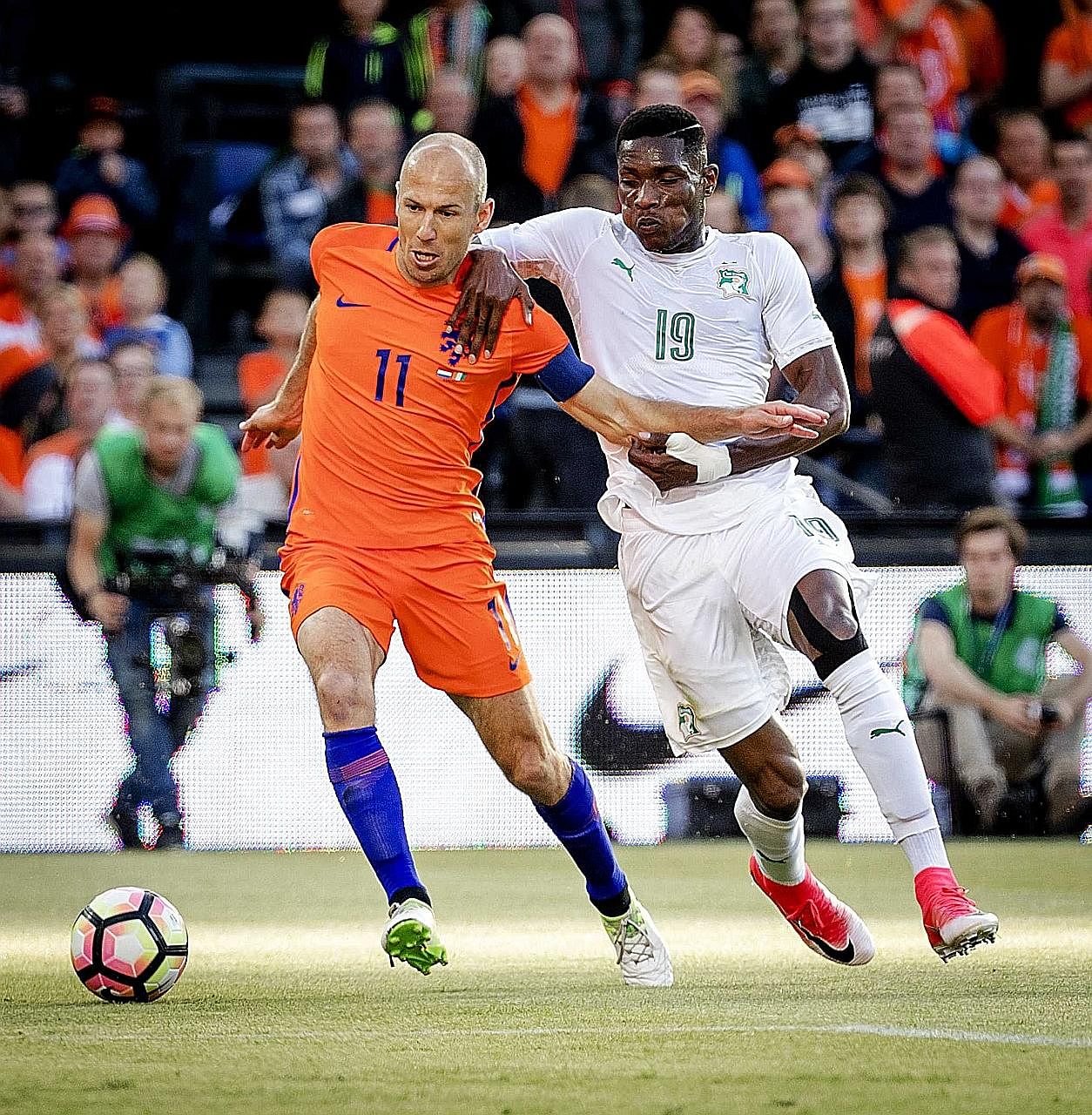 Netherlands captain Arjen Robben shielding the ball from Ivory Coast defender Simon Deli during a friendly in Rotterdam. The hosts won 5-0, with Robben scoring their second last Sunday.