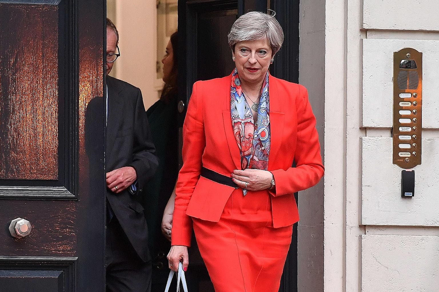 Mrs Theresa May leaving the Conservative Party HQ in London yesterday, hours after the polls closed in the British general election.