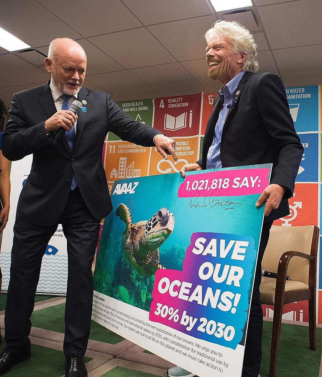 UN General Assembly president Peter Thomson (far left) and Mr Richard Branson with the petition carrying over one million signatures. The petition urges governments to protect at least 30 per cent of the world's oceans by 2030.