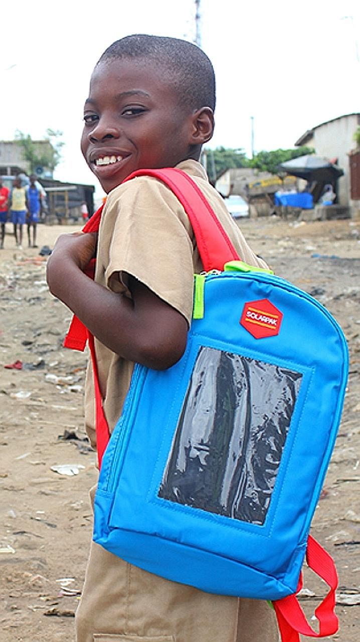 An Ivorian child carrying a Solarpak. Mr Evariste Akoumian hopes his project will provide easy access to electricity in Africa, where 700 million people live without power.