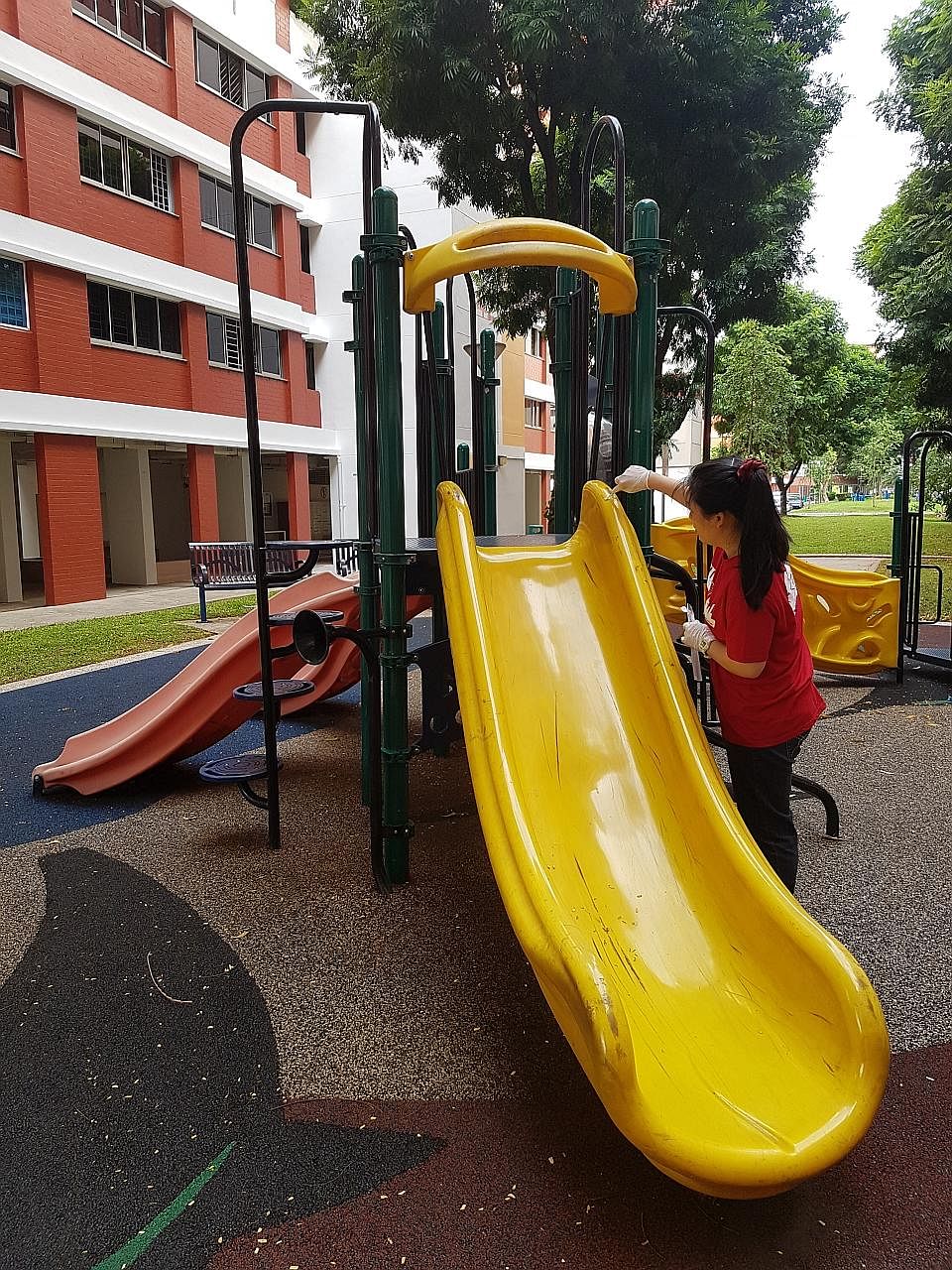 A volunteer from A*Star swabbing the surfaces of a playground in Singapore. The sample is among the 1,000 that will be sent to New York to be analysed for genetic information. The study will give researchers a glimpse of the bacteria, viruses and gen