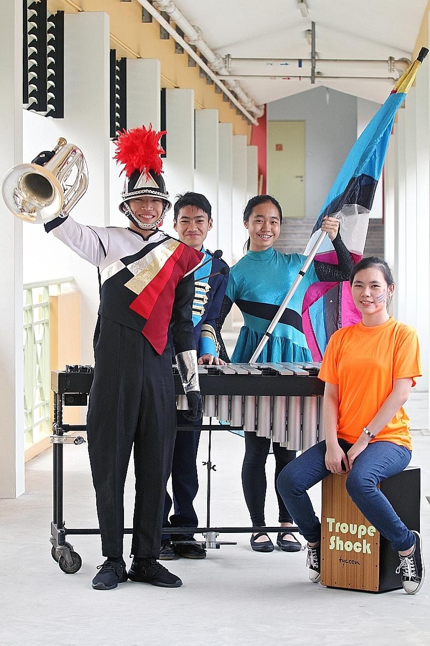 Hassanah Kazali, 15, from Rainbow Centre playing the handbells. Left: Clarinetist Quek Zhi Zuan (far left), 13, and trumpet section leader Tan Jie Ling, 14, from Bukit Panjang Government High School at the combined rehearsal. Right: Shakthi Priya Ram