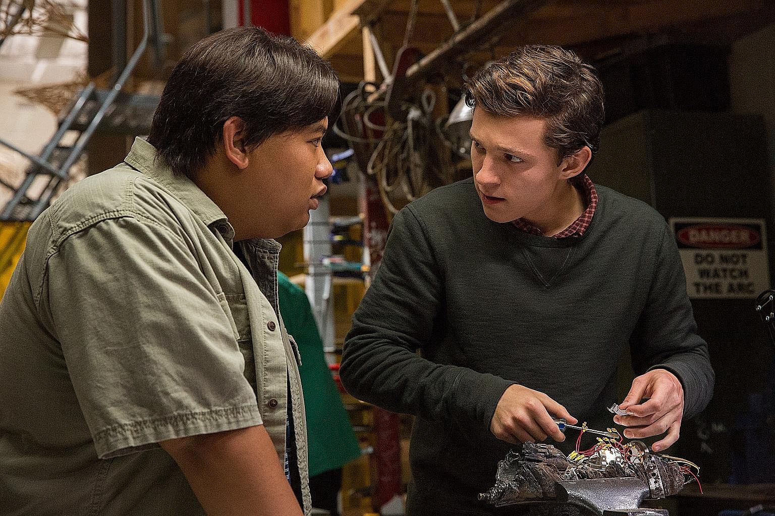 Playing the web-slinger and high school student Peter Parker in Spider-Man: Homecoming is Tom Holland (right), while Jacob Batalon stars as his best friend Ned.