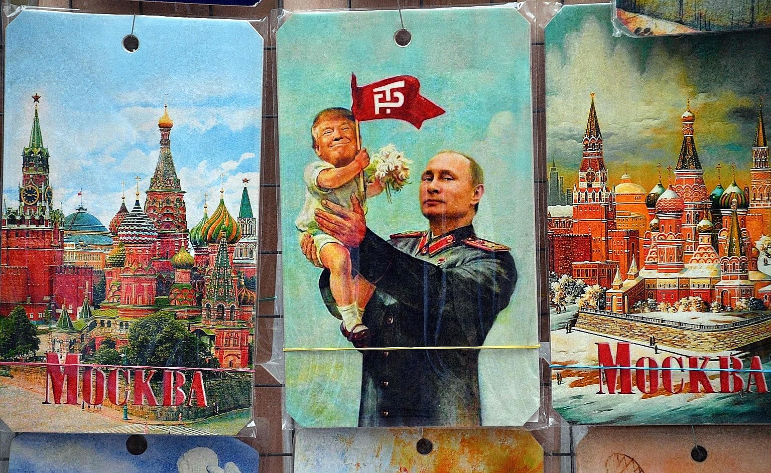 A drawing on sale in a souvenir shop in Moscow depicting Russian President Vladimir Putin holding a baby with the face of US President Donald Trump, based on an old propaganda poster showing former Soviet leader Joseph Stalin holding a baby. The firs