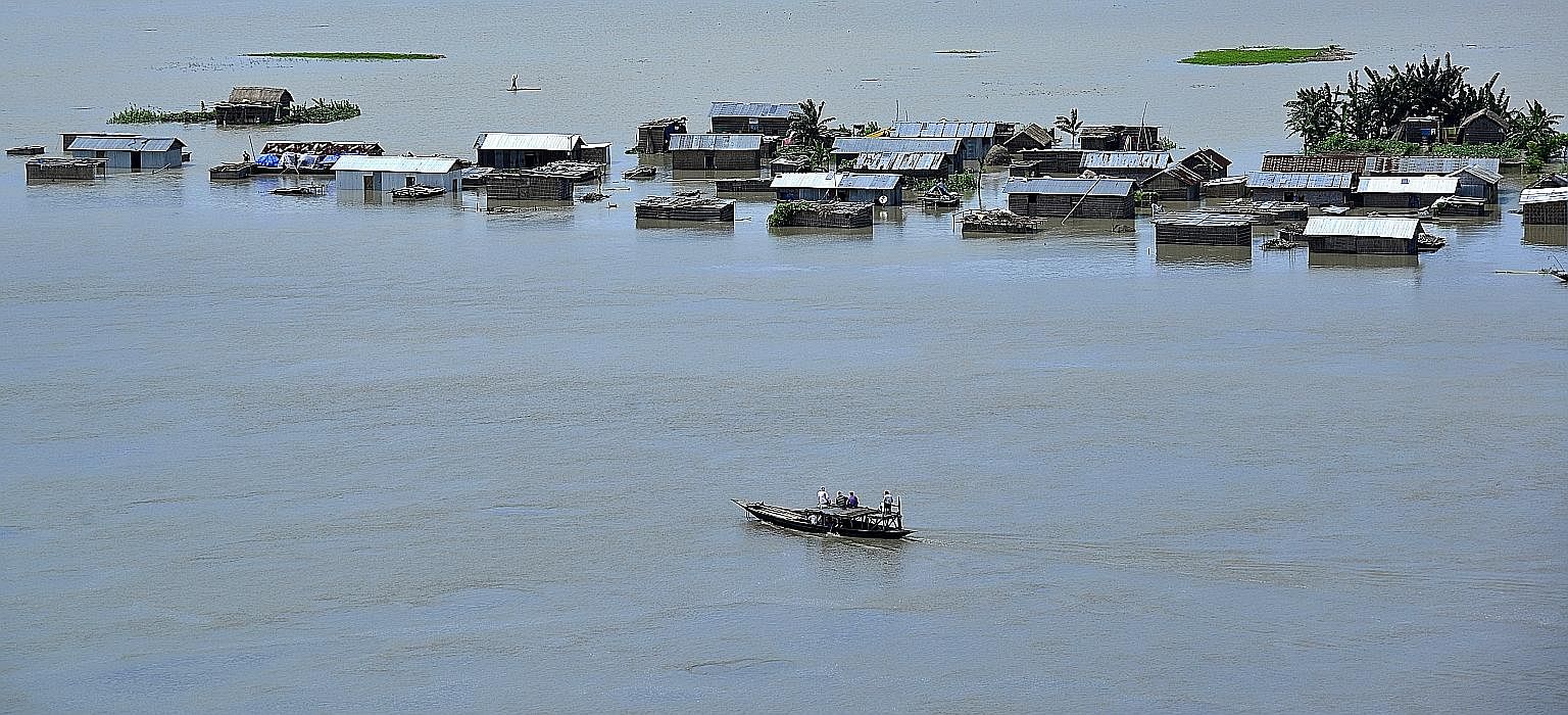 Submerged homes in Assam on Wednesday. Five rivers have risen to dangerous levels.