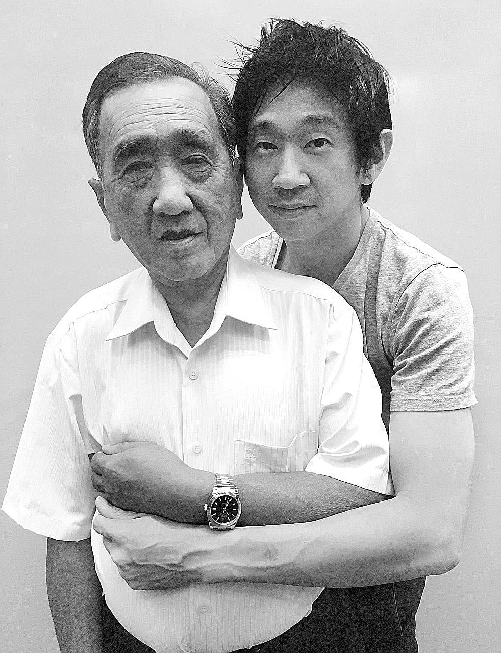 Photographer John Clang with his father Ang Ching Seong, who is wearing his son's Rolex Milgauss watch (above).