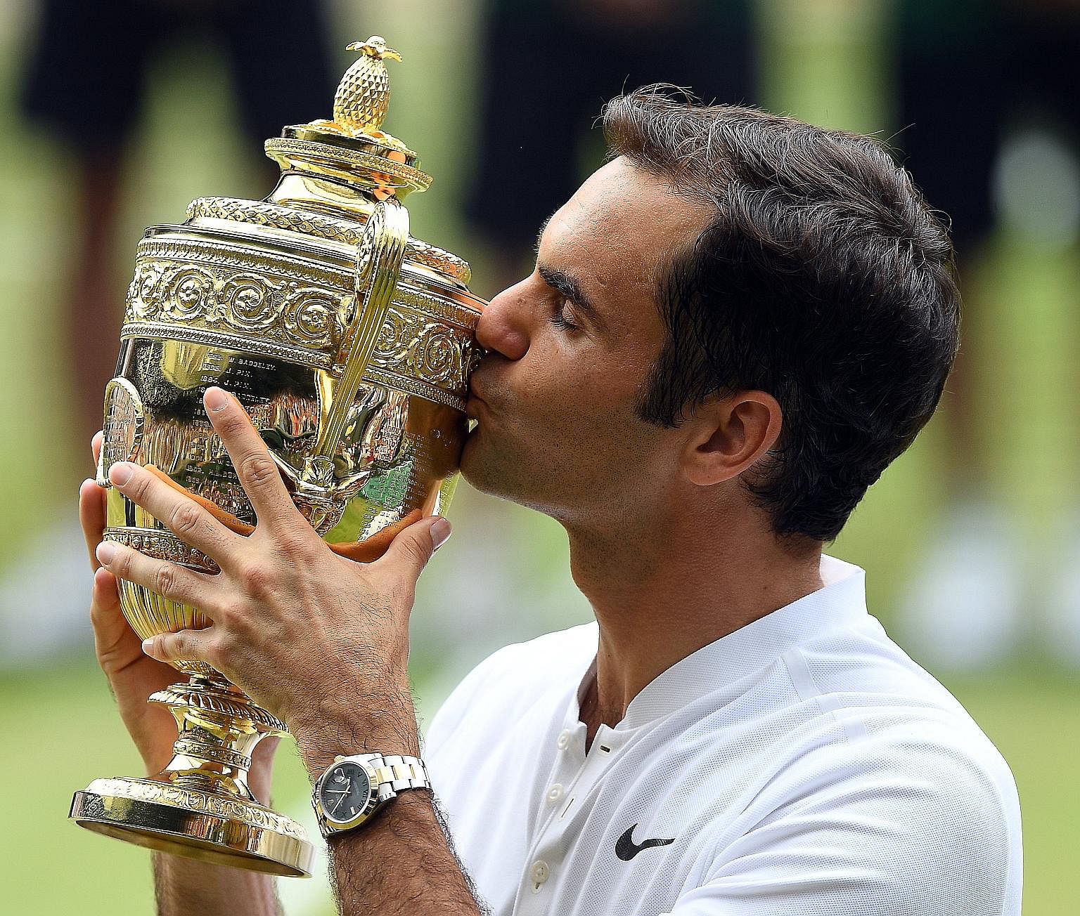 Roger Federer kissing the Wimbledon trophy. With his eighth title at the All England Club, he holds the record for most men's singles crowns alone after sharing it with American Pete Sampras and Briton William Renshaw since 2012.