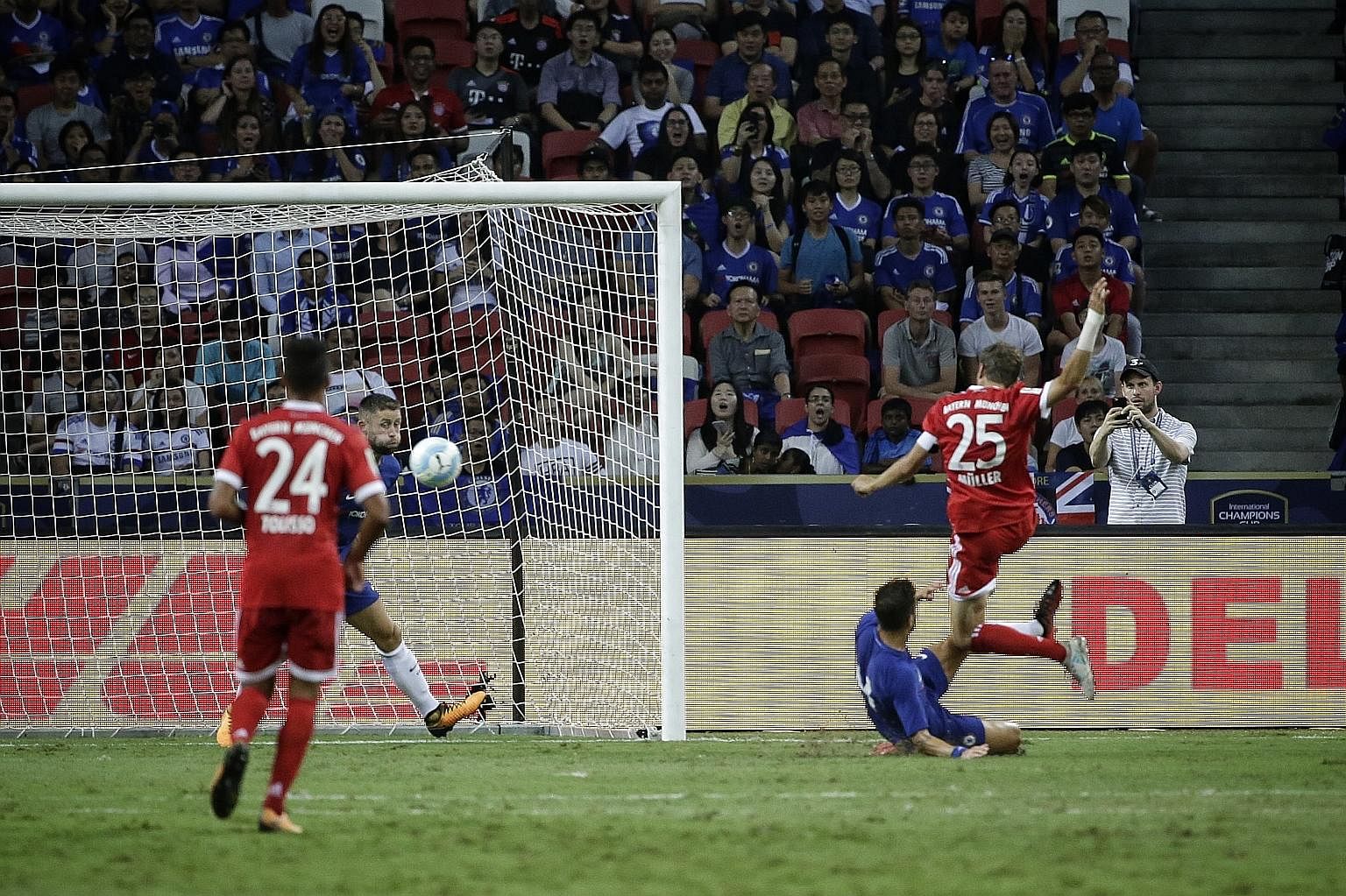 Bayern Munich forward Thomas Muller (jersey No. 25) slamming the ball home for his club's second goal in their 3-2 win over English Premier League champions Chelsea in the first match of the International Champions Cup at the National Stadium last ni