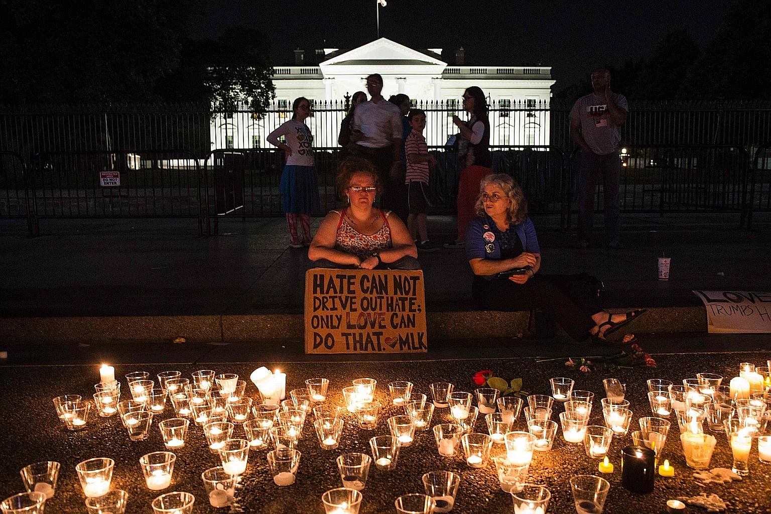 People gathering in front of the White House on Sunday for a vigil in response to the deadly violence at the Aug 12 rally in Charlottesville. Over the past week, Mr Donald Trump has indulged in nuclear brinkmanship with North Korea and flirted with w