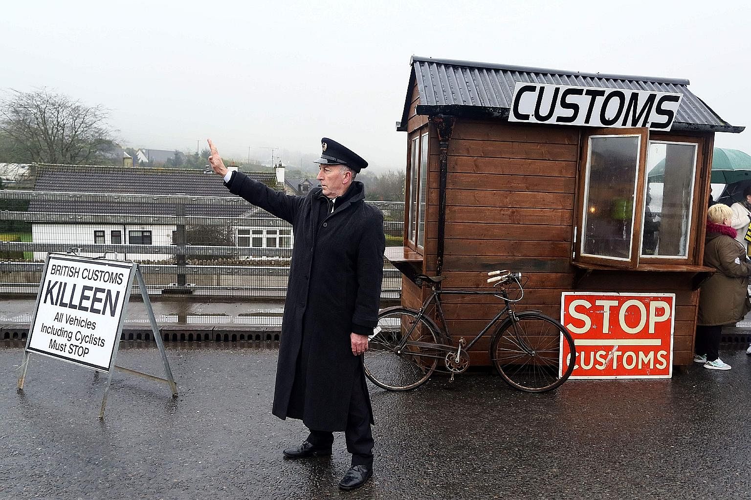 A demonstrator dressed as a Customs official at a mock checkpoint near Dundalk, Ireland, protesting against potential border checks into Northern Ireland following Brexit.