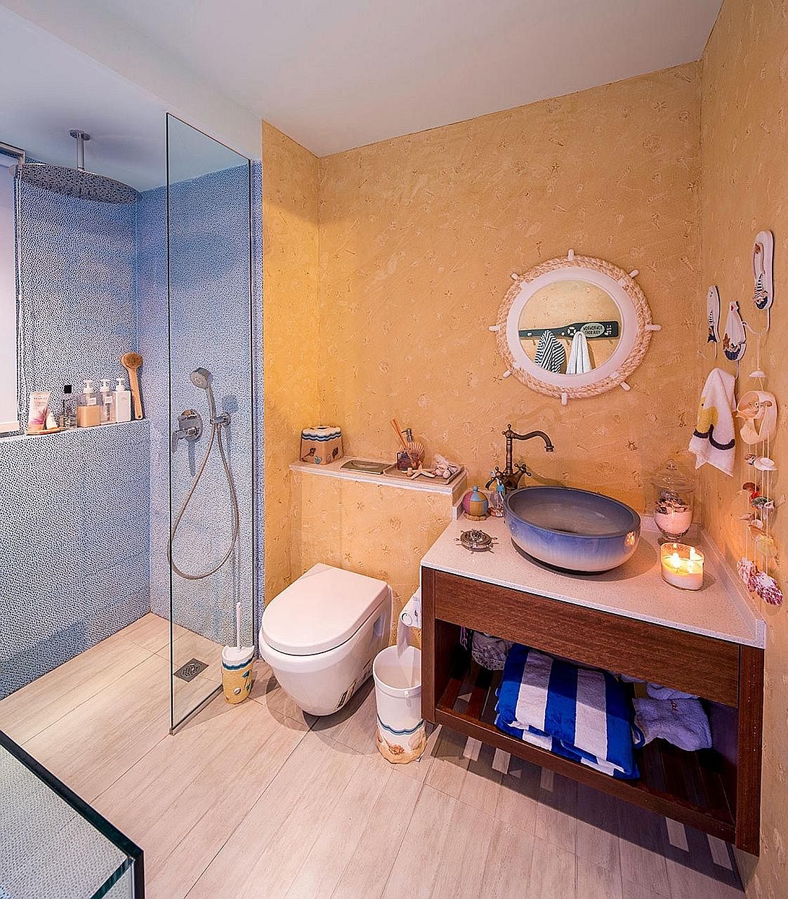 Blue tiles, to replicate the hues of the sky and the ocean, as well as sand-textured walls re-create the Maldivian beach villa vibe in the master bathroom (above). Home owners Kenneth Tan and Jael Tan (both left) with their children, Odette, one, and