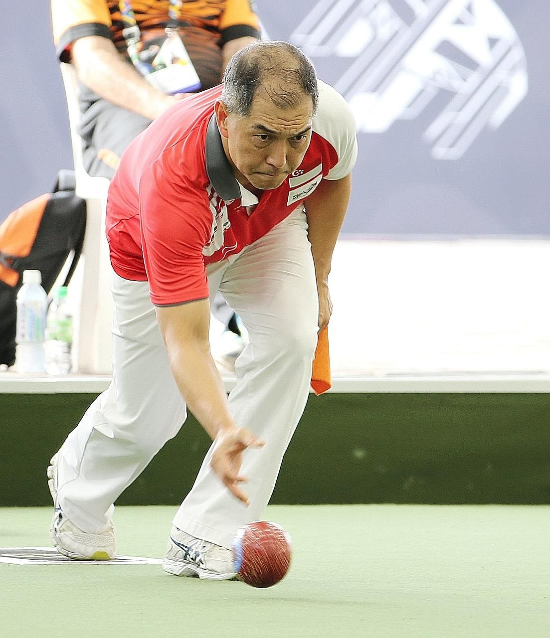Lee Yuan Min competing in the lawn bowls men's singles final against Malaysia's Muhammad Soufi Rusli. He lost 6-21 but his silver makes him Team Singapore's oldest medallist at the Kuala Lumpur Games.