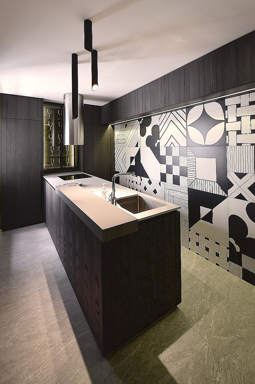 Mr Yeo See Wee and Ms JJ Yip used hand-drawn Italian tiles with busy patterns to create a feature wall in the kitchen.